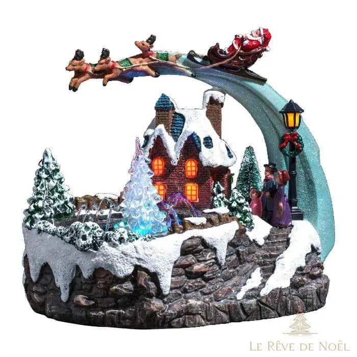 Village lumineux de Noël avec traineau